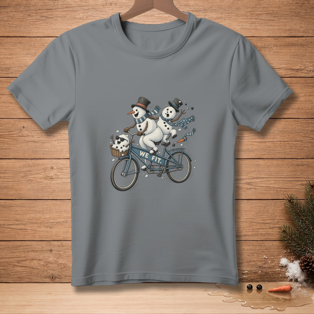 Two snowmen riding a tandem bicycle with "WE FIT." text on the frame.