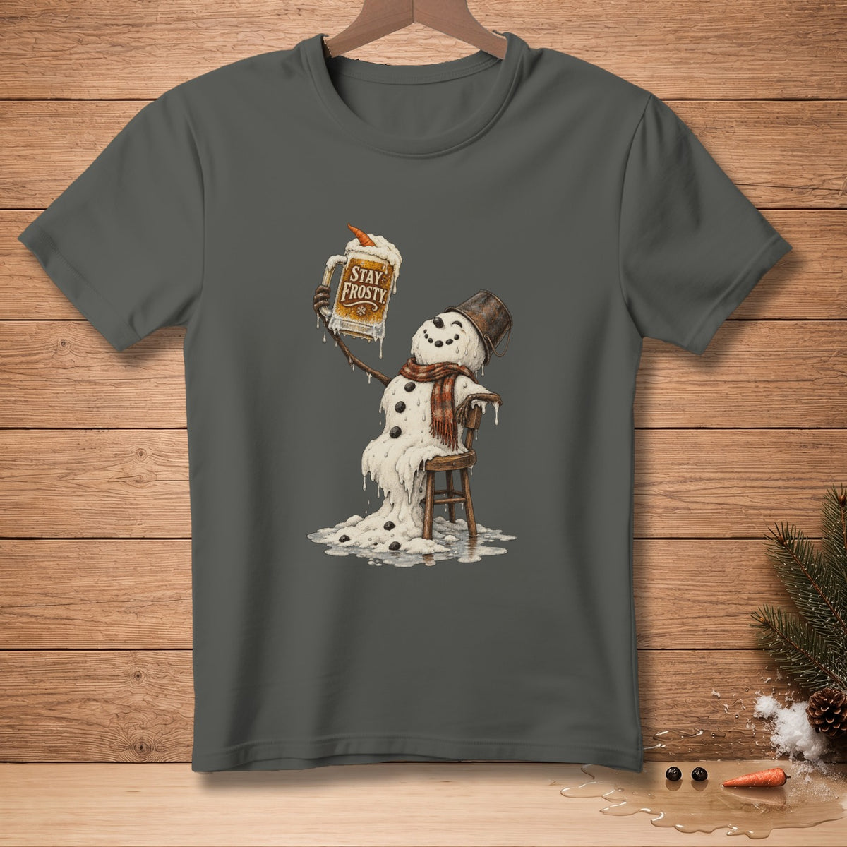 Melting snowman in scarf and bucket hat holds a mug that says "Stay Frosty".