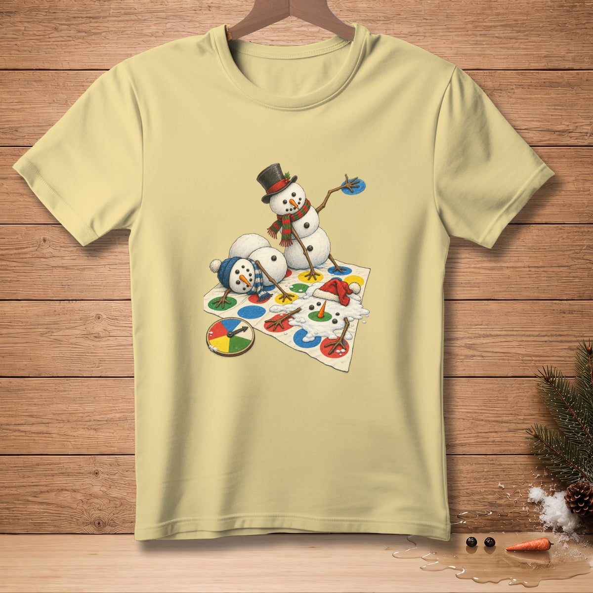 Snowmen playing Twister, one melting, on a cream t-shirt.