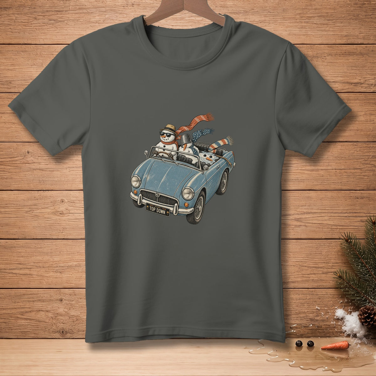 Snowmen in a convertible car with scarves and sunglasses, license plate reads "TOP DOWN".
