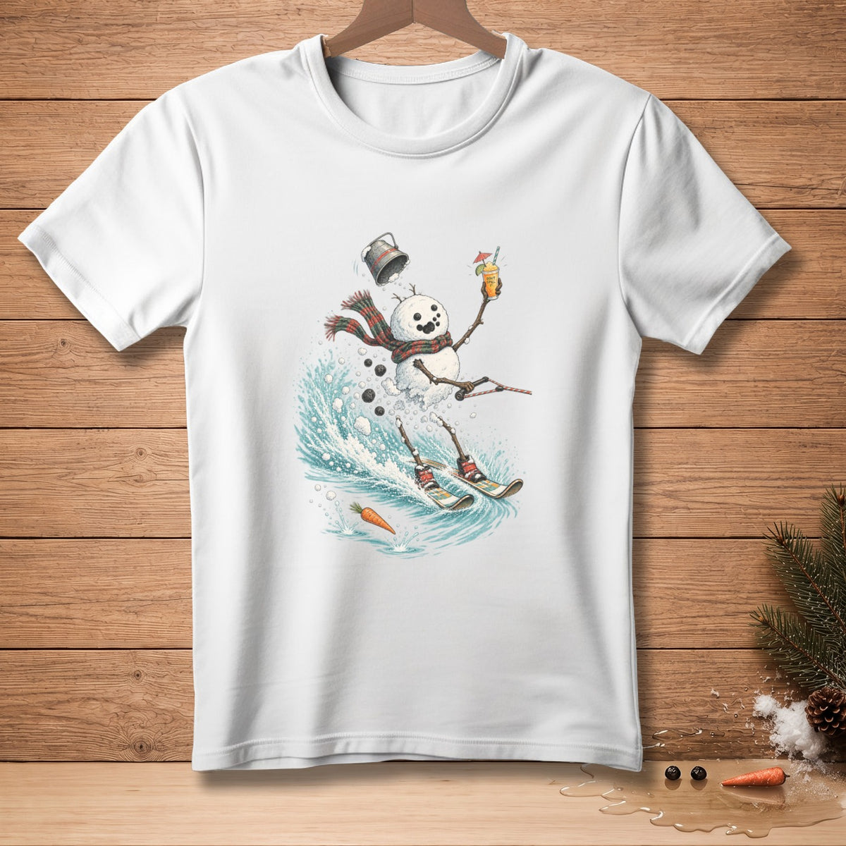 White t-shirt featuring a cartoon snowman surfing a wave while holding a drink.