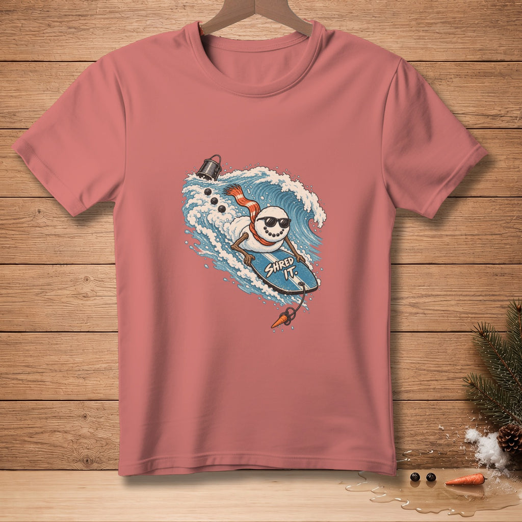 Snowman surfing on a wave with text "SHRED IT" on the surfboard.