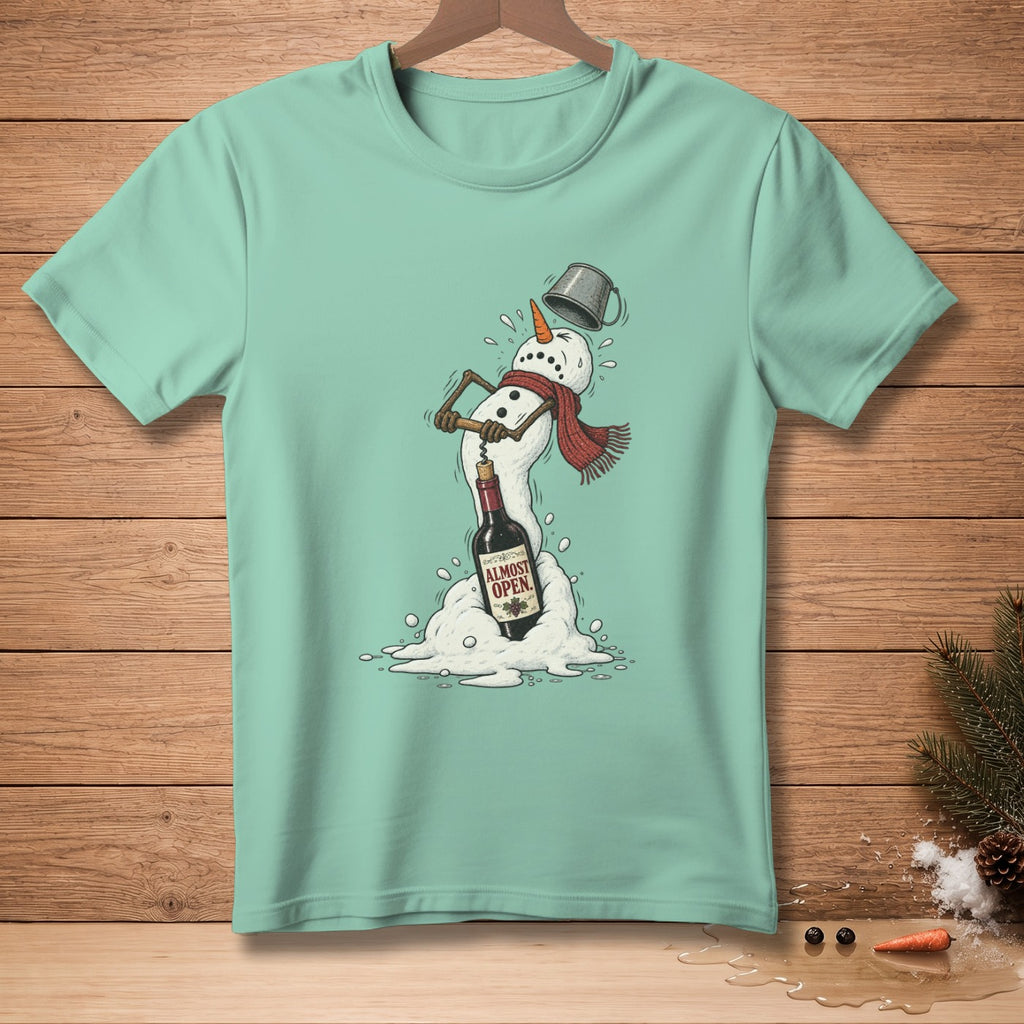 Mint green t-shirt with a melting snowman opening a bottle of wine.
