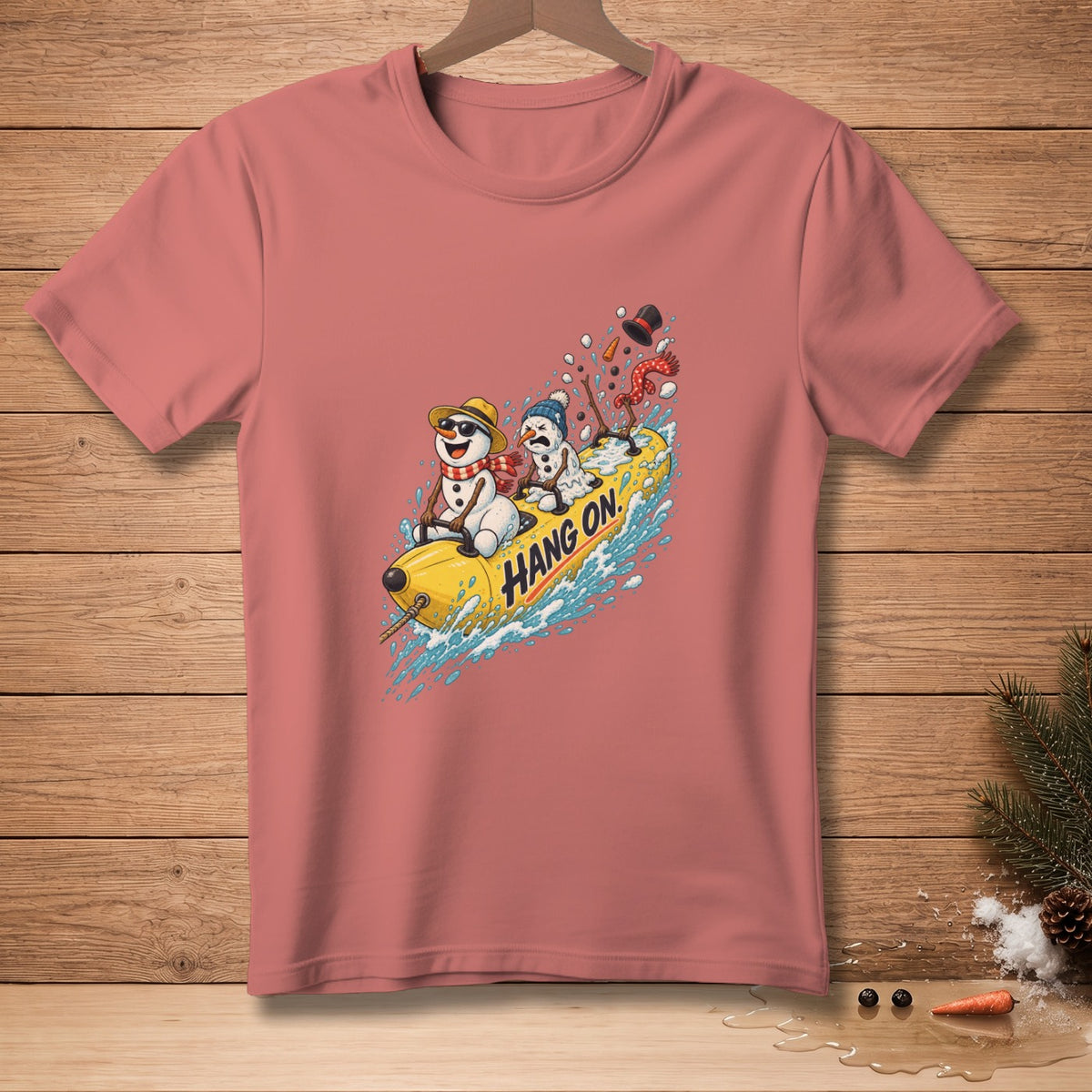 T-shirt with cartoon snowmen riding a banana boat, saying "Hang On."