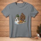 Bigfoot and a melting snowman at a campsite by a campfire.