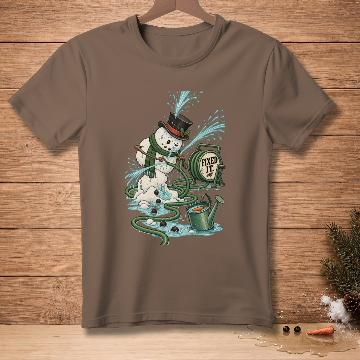 Snowman with a hose spraying water with "FIXED IT." text on a brown t-shirt.