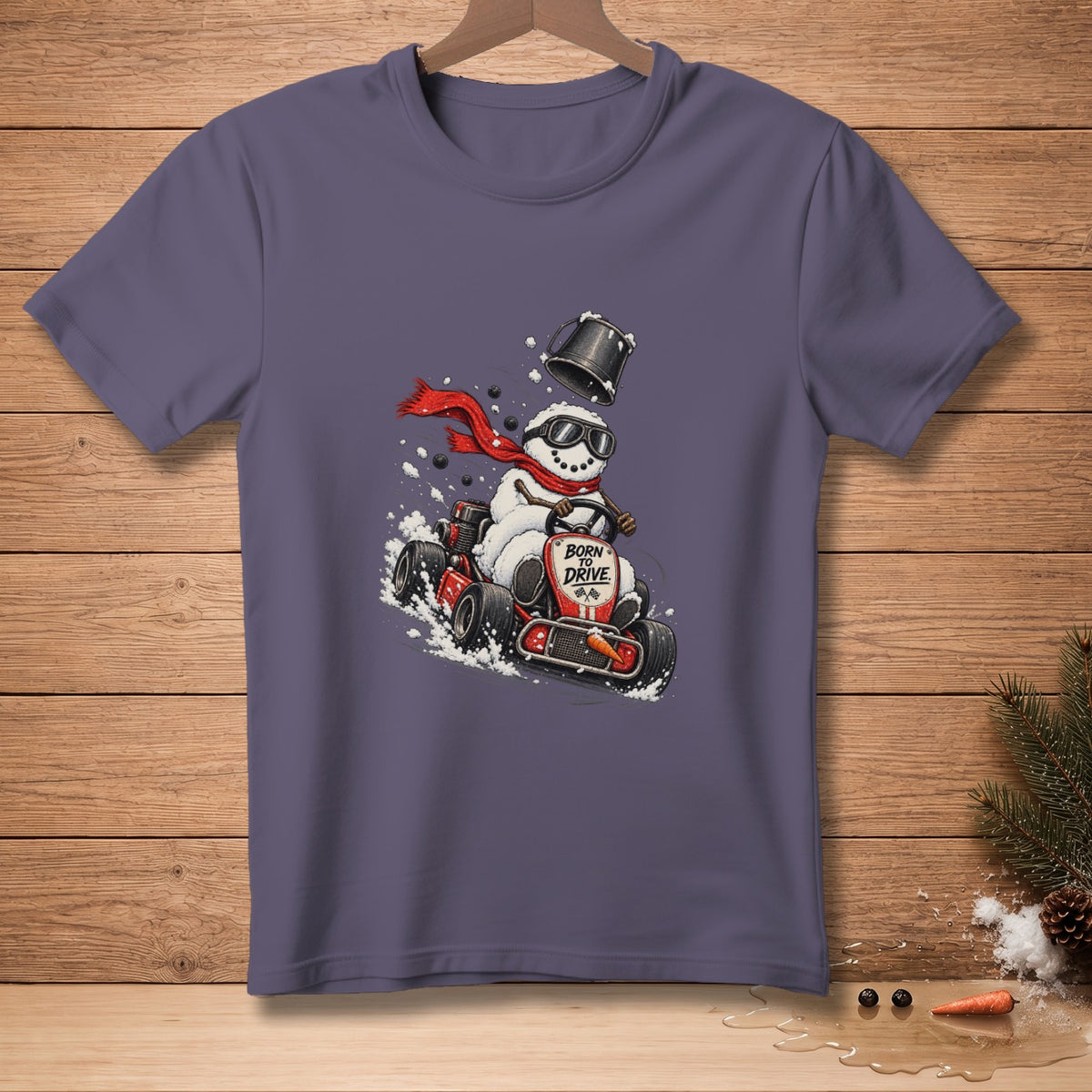 Snowman in go-kart with sunglasses and red scarf, text "BORN TO DRIVE".