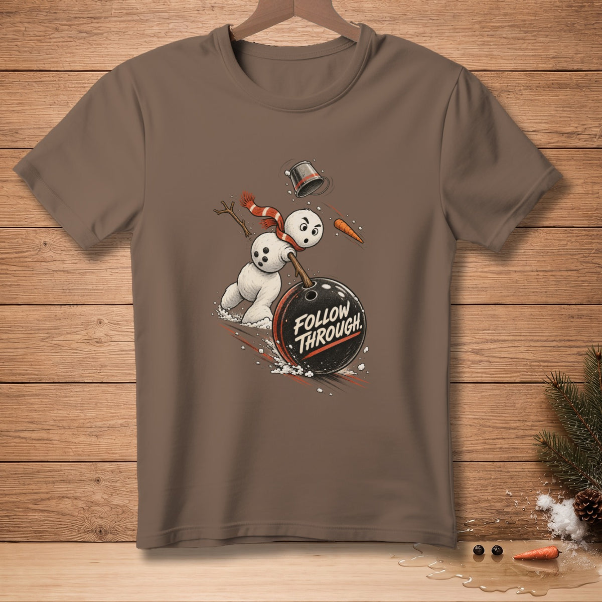 Brown t-shirt with a cartoon snowman bowling, text "FOLLOW THROUGH".