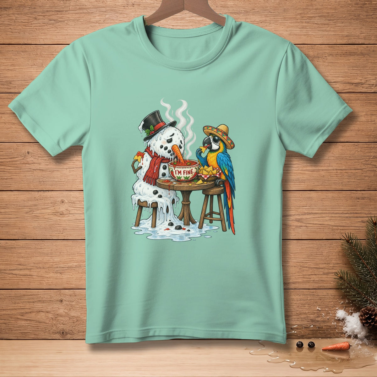 Melting snowman and parrot eating nachos with "I'm Fine" dip on mint green t-shirt.