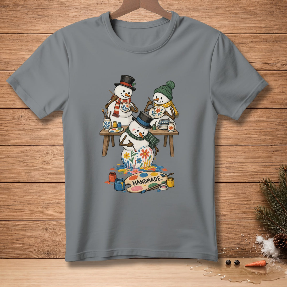 Three snowmen painting flowers on a palette with the word HANDMADE.