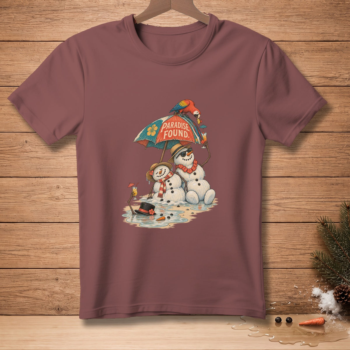 Two snowmen under an umbrella with "Paradise Found" text on a maroon t-shirt.