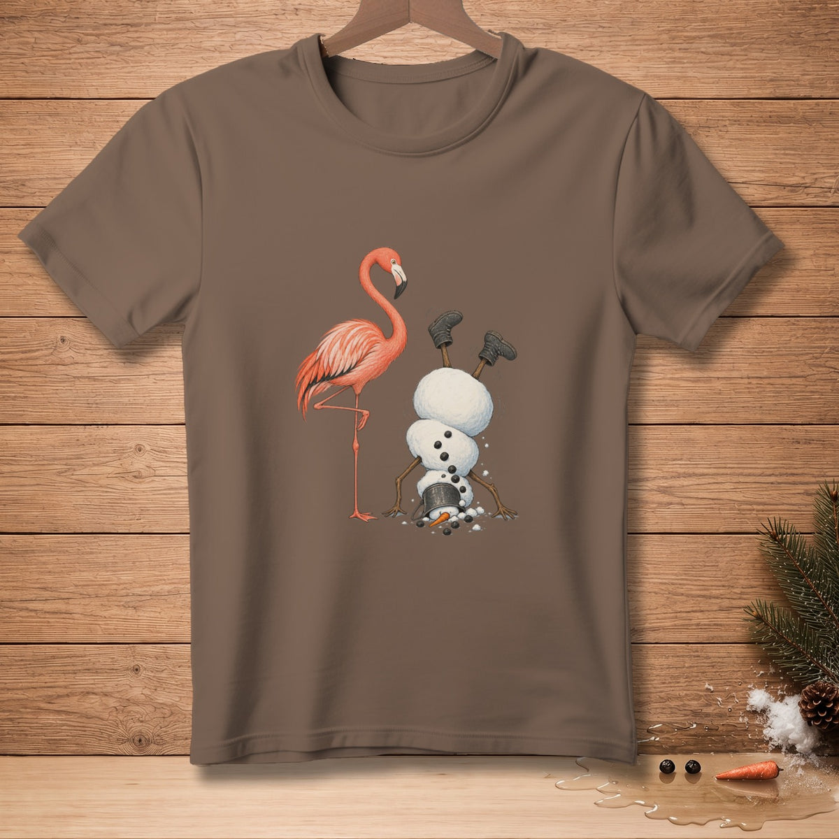 Flamingo and upside-down snowman graphic on a brown t-shirt.