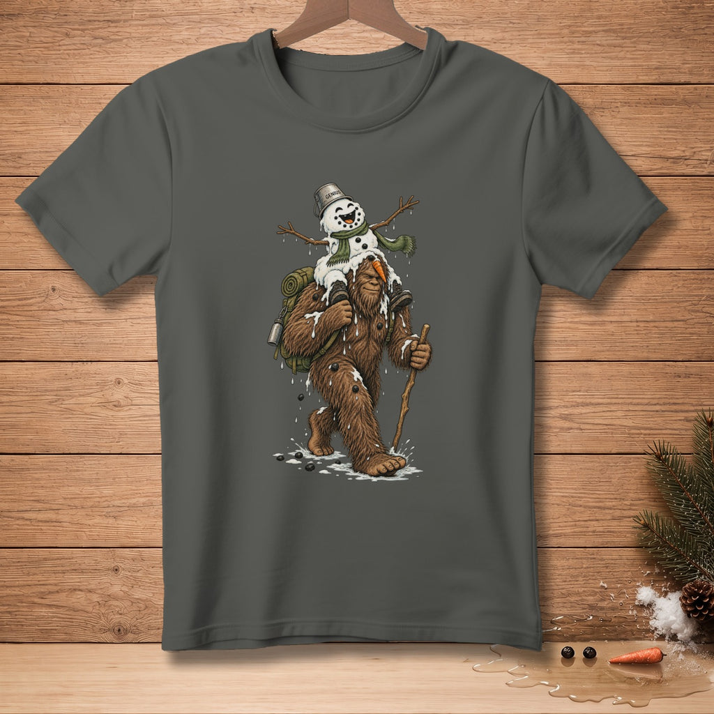 Bigfoot carries a melting snowman with a bucket that says "GENIUS" on a dark grey t-shirt.