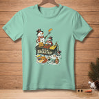 Snowmen cooking breakfast on a griddle with text "TEAM BREAKFAST" on a mint t-shirt.