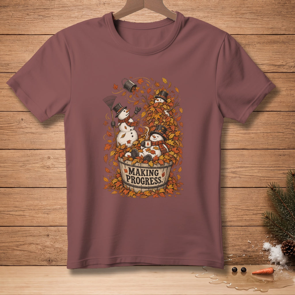 Snowmen in a bucket of leaves with text "MAKING PROGRESS" on a maroon shirt.