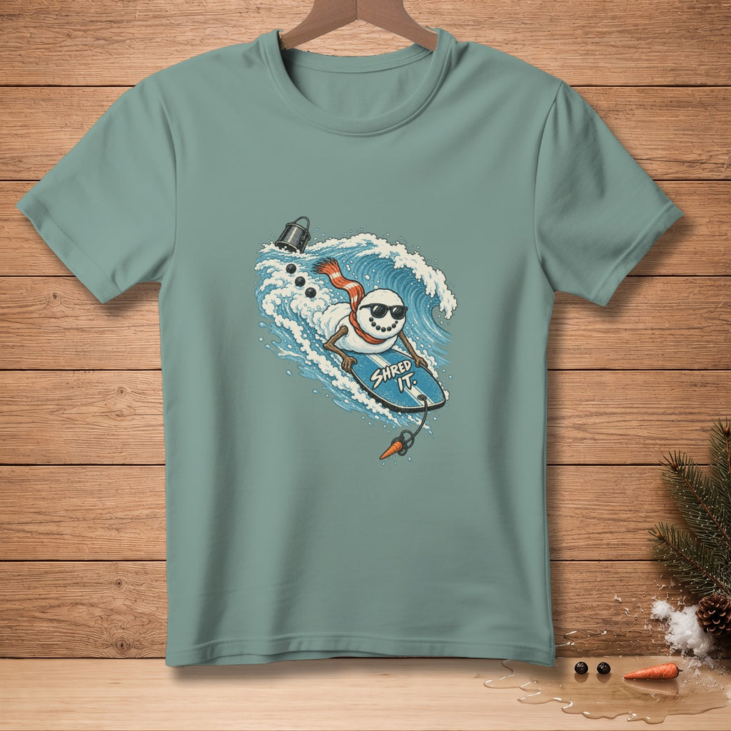 Snowman with sunglasses surfs a wave on a blue board with "SHRED IT" text.