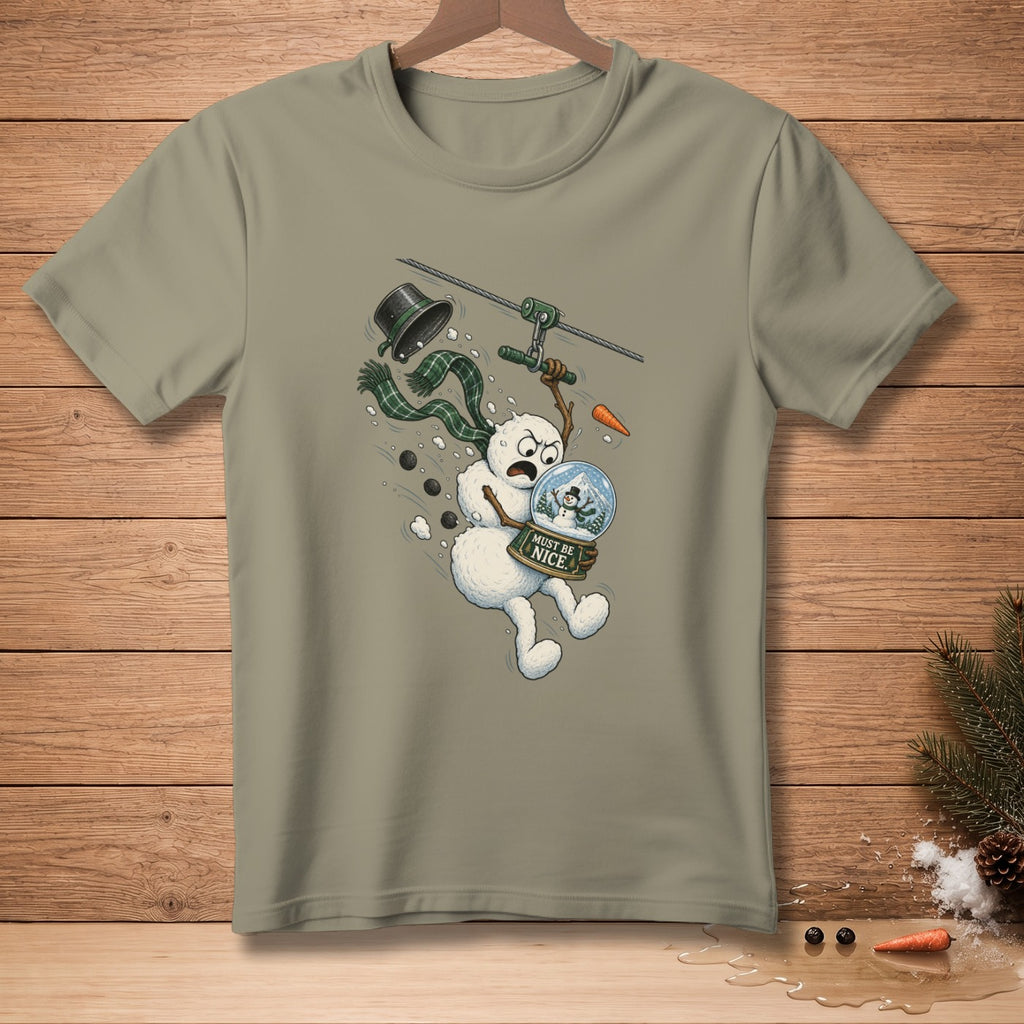 Snowman ziplining holding snow globe with "Must Be Nice" text.
