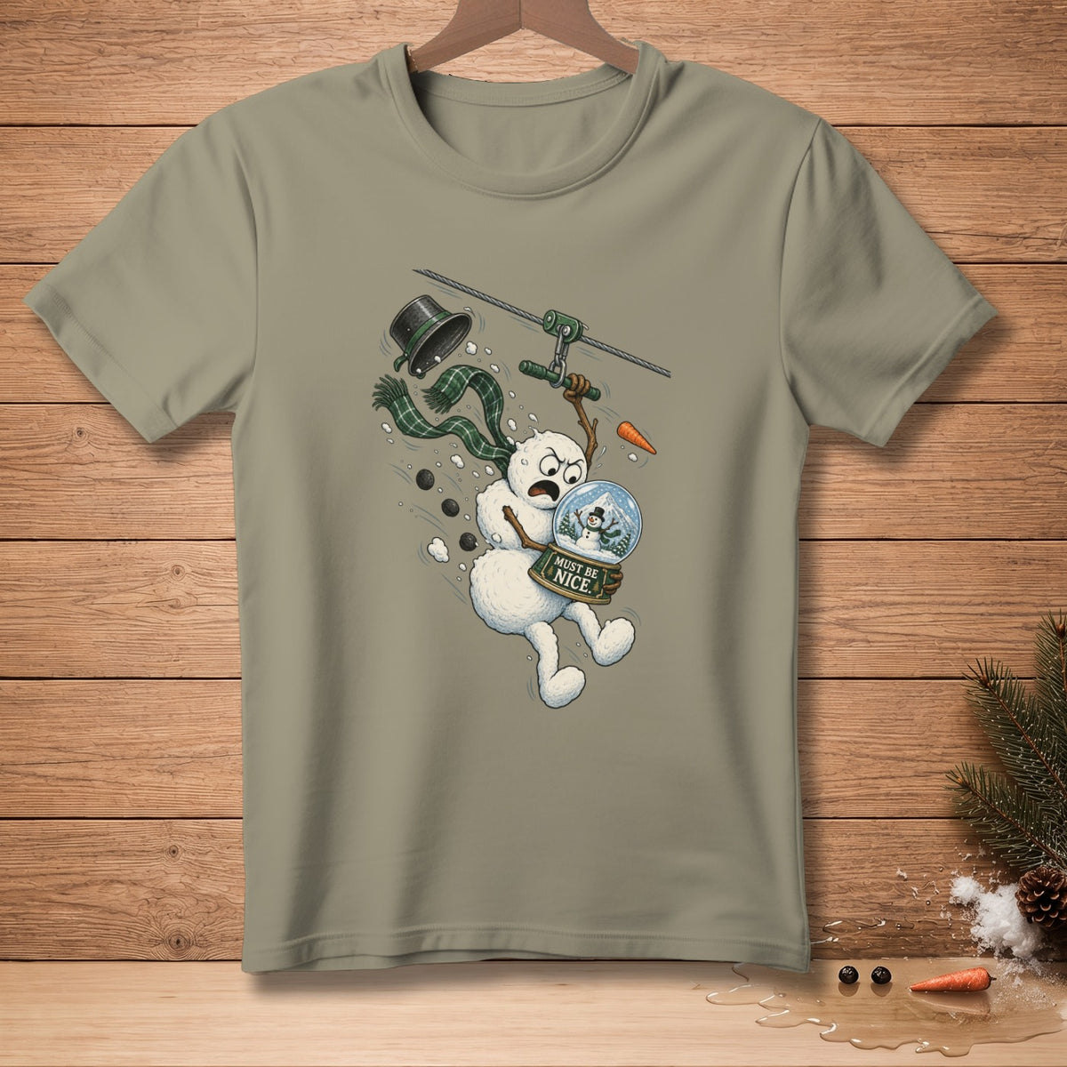 Snowman ziplining holding snow globe with "Must Be Nice" text.