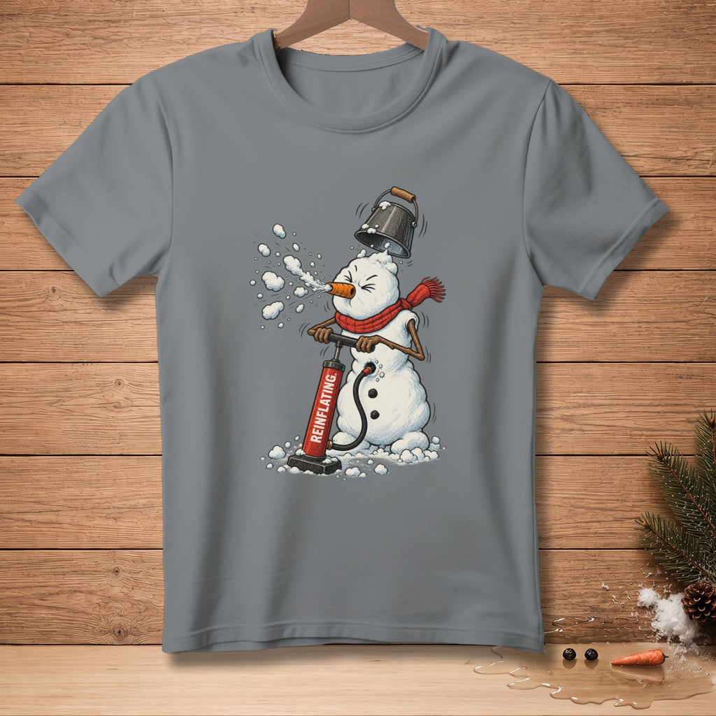 Snowman inflating itself with a red pump labeled "REINFLATING" on a grey t-shirt.