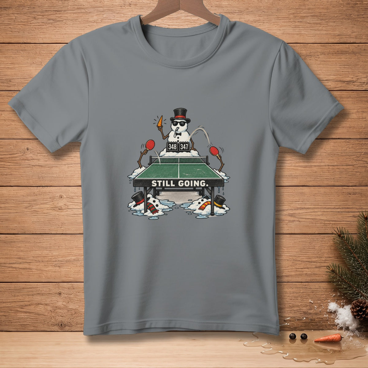 Snowmen playing ping pong with score 348-347 and text "STILL GOING."