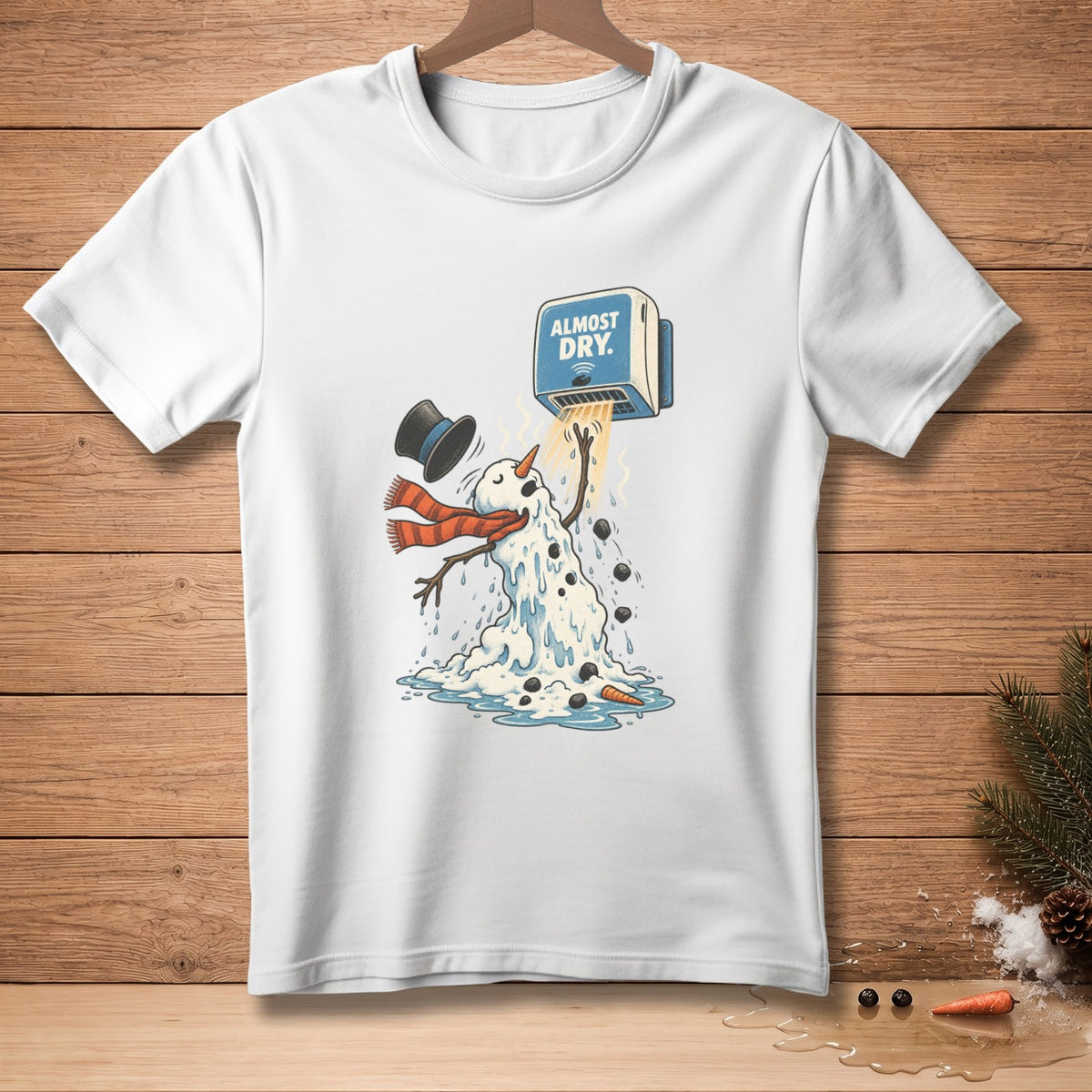 White t-shirt with melting snowman under hand dryer that says "ALMOST DRY."