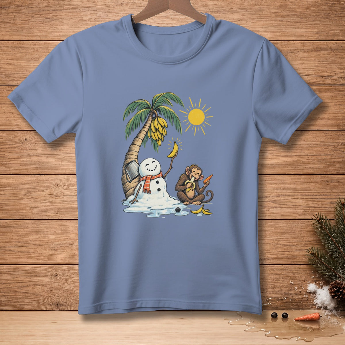 Blue t-shirt with cartoon of melting snowman, banana tree, sun, and monkey eating carrot.