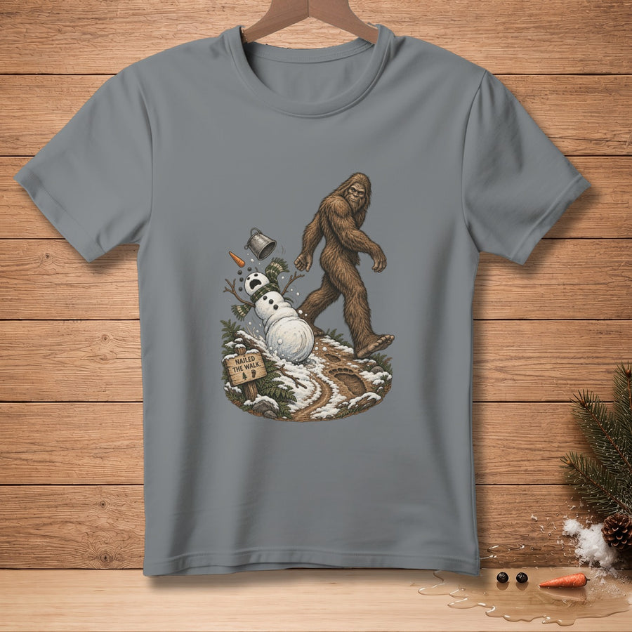 Bigfoot walks past a melting snowman with a sign that reads "Nailed the walk."