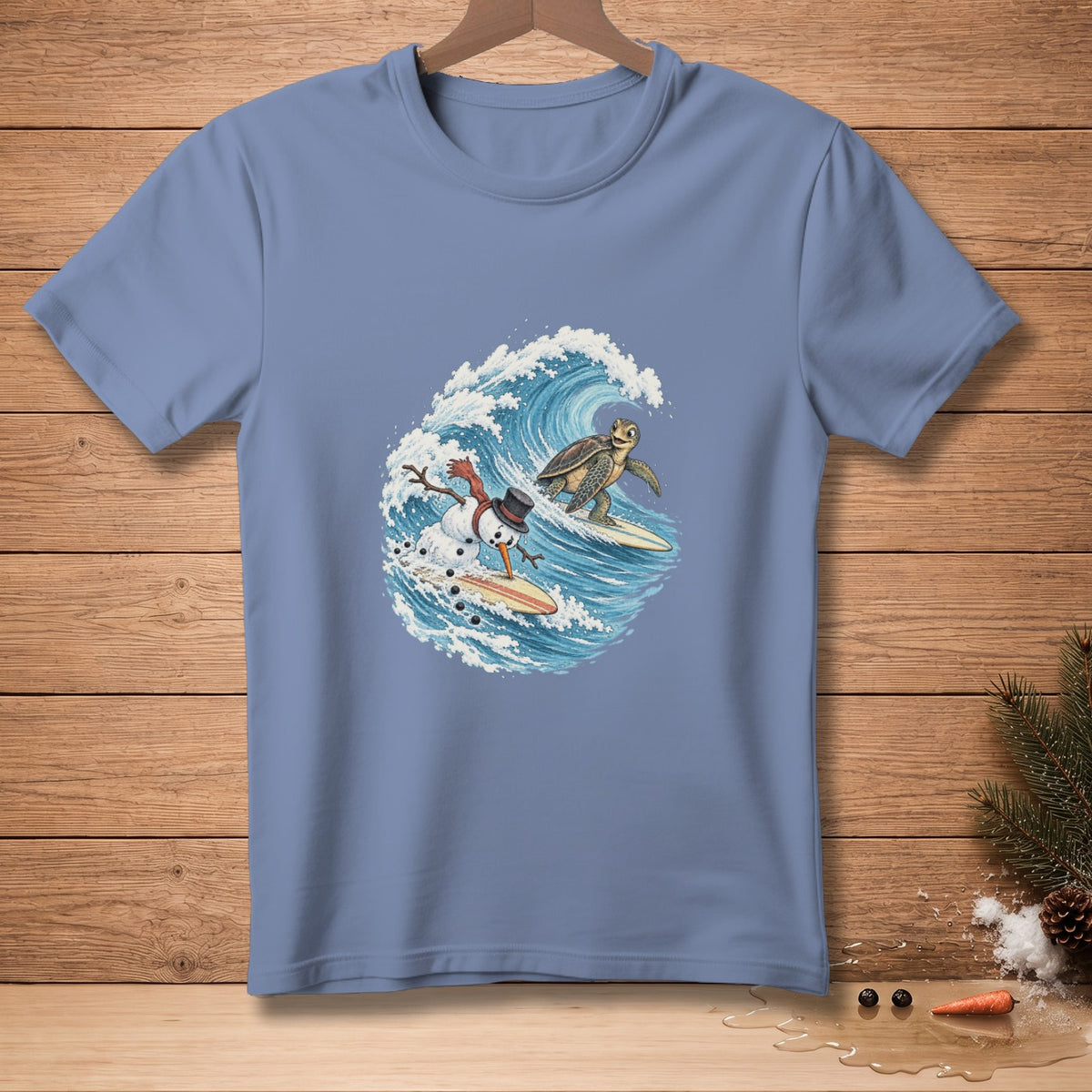 Snowman and turtle surfing on waves on a blue t-shirt.
