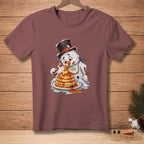 Melting snowman in top hat eats stack of pancakes with syrup, wearing "Light & Fluffy" bib.