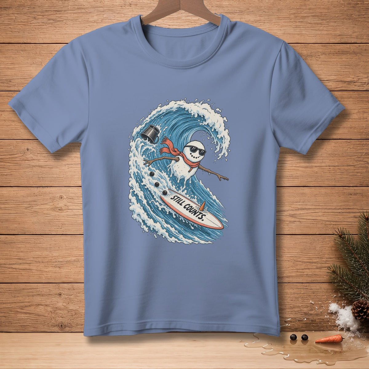 Snowman surfing a wave on a surfboard with "Still Counts." text.