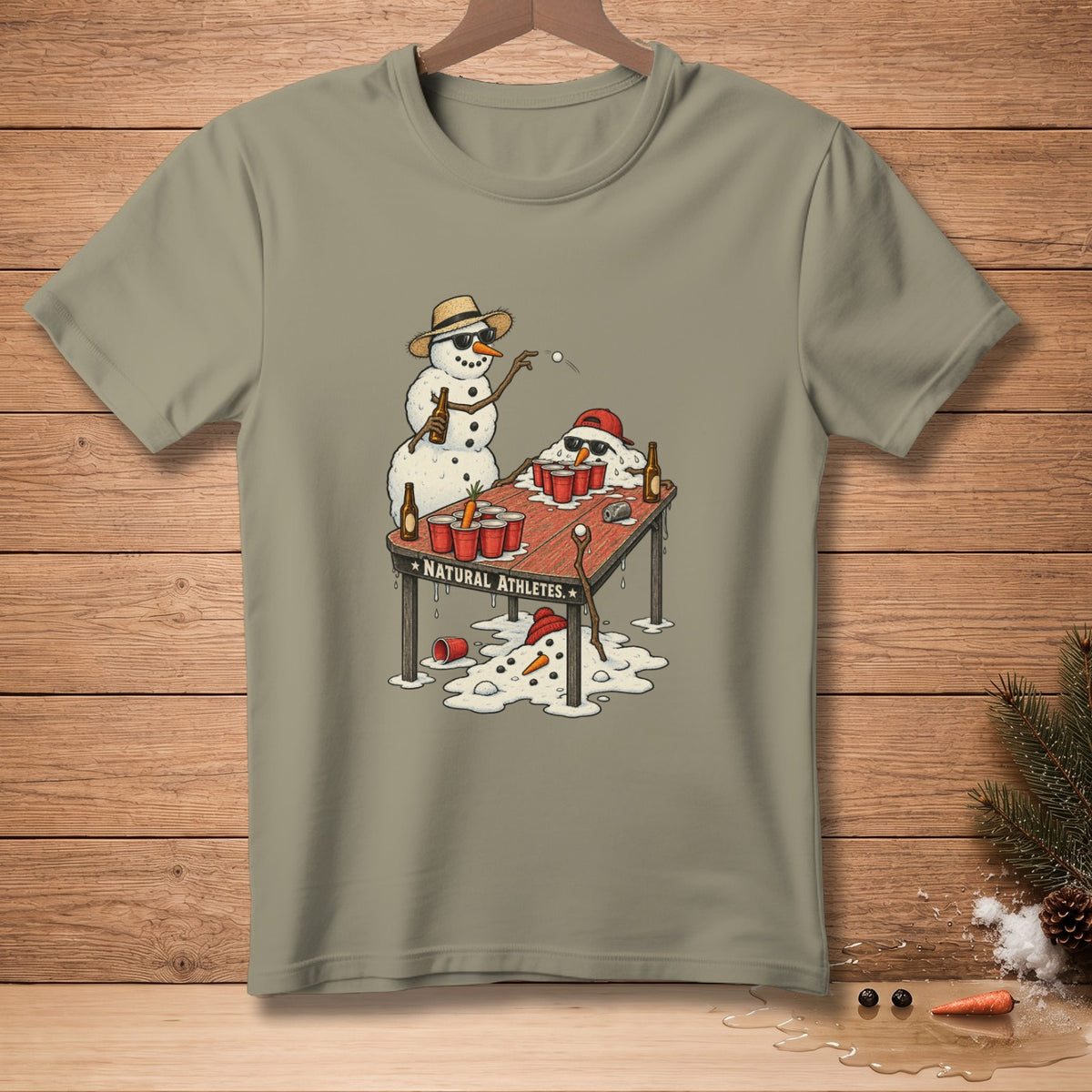 T-shirt graphic of snowmen playing beer pong with melted snowmen and red cups.