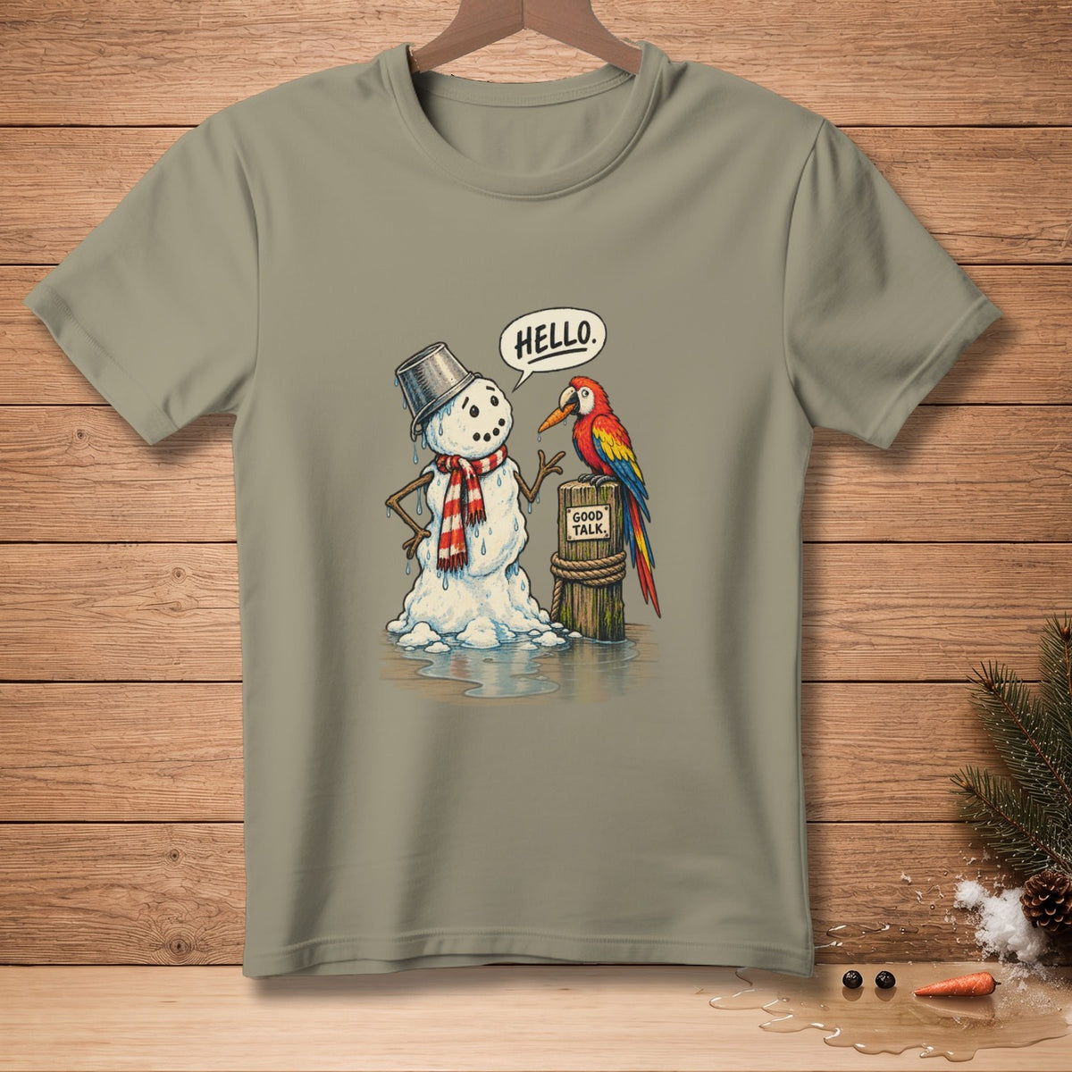T-shirt graphic: Melting snowman says "HELLO" to parrot on a post saying "GOOD TALK."