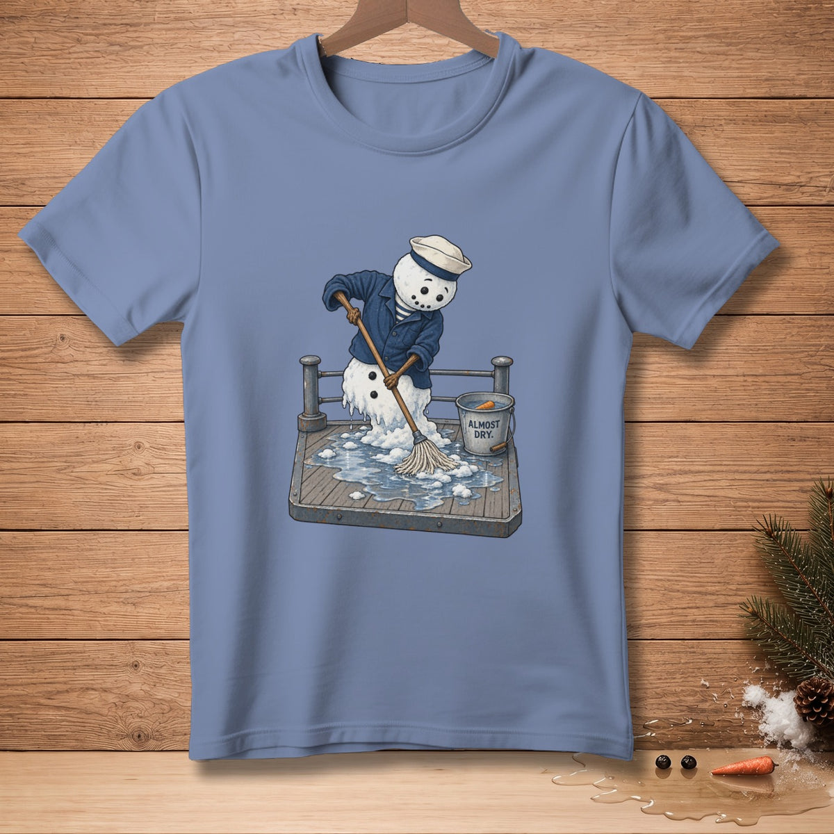 Melting snowman in sailor uniform mops up a puddle, bucket reads "Almost Dry".