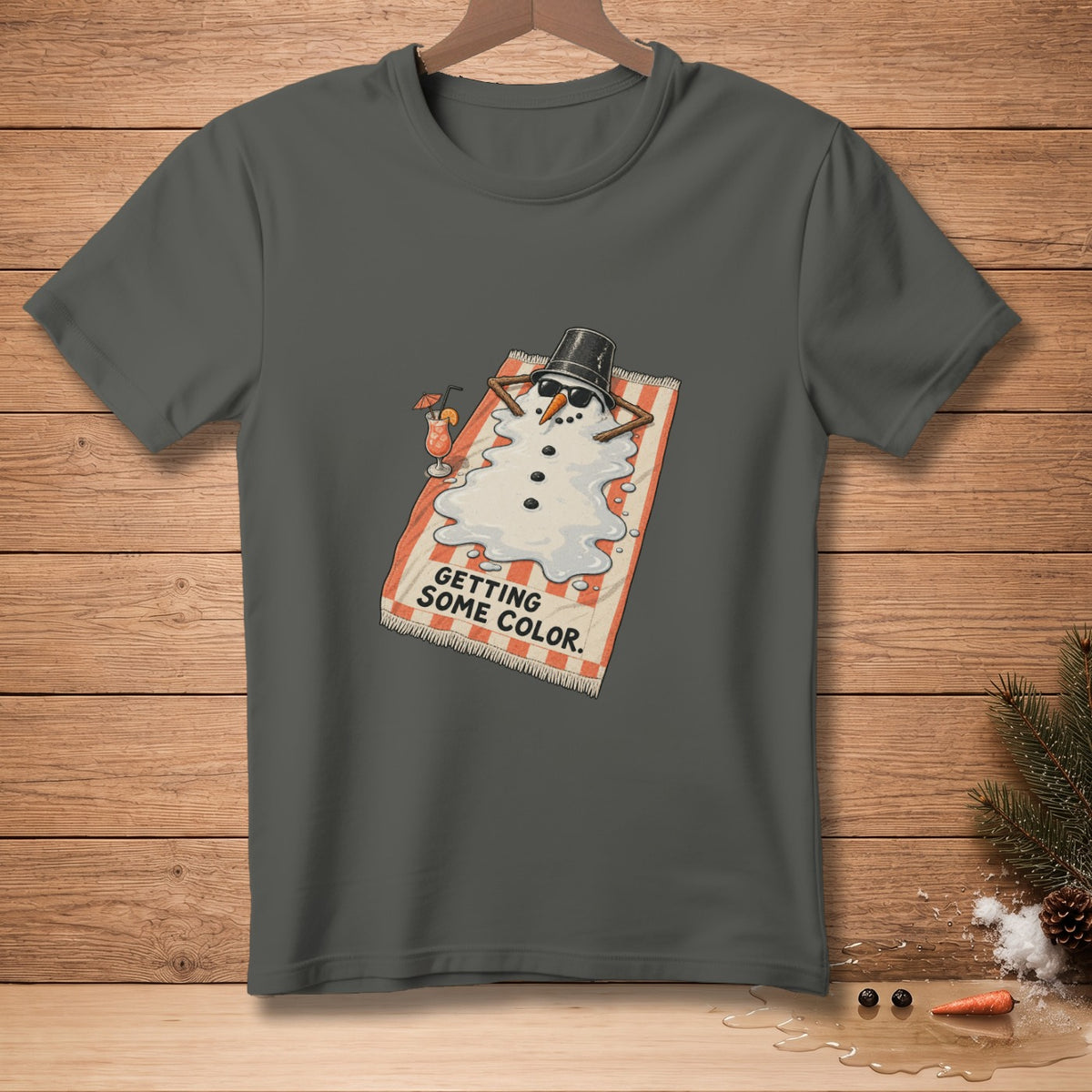T-shirt with melting snowman on towel, text "GETTING SOME COLOR."