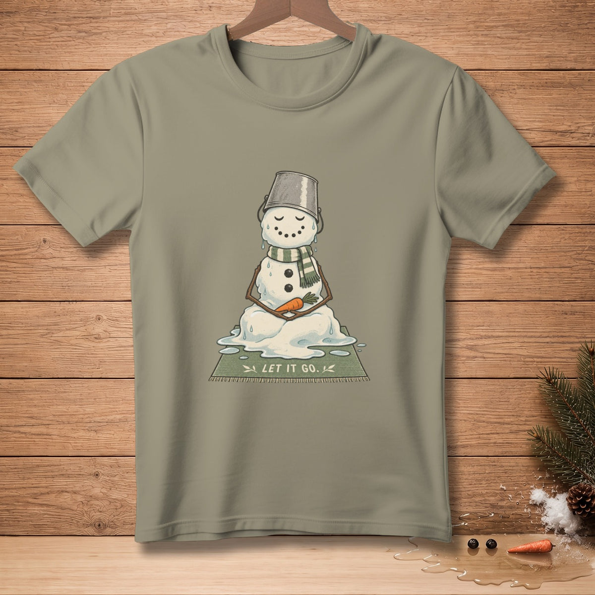 Melting snowman with bucket hat, scarf, and carrot nose on a rug reading "LET IT GO."