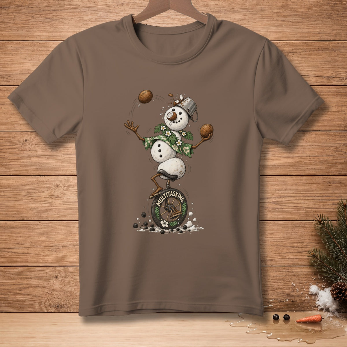Brown t-shirt with a snowman juggling coconuts while riding a unicycle.