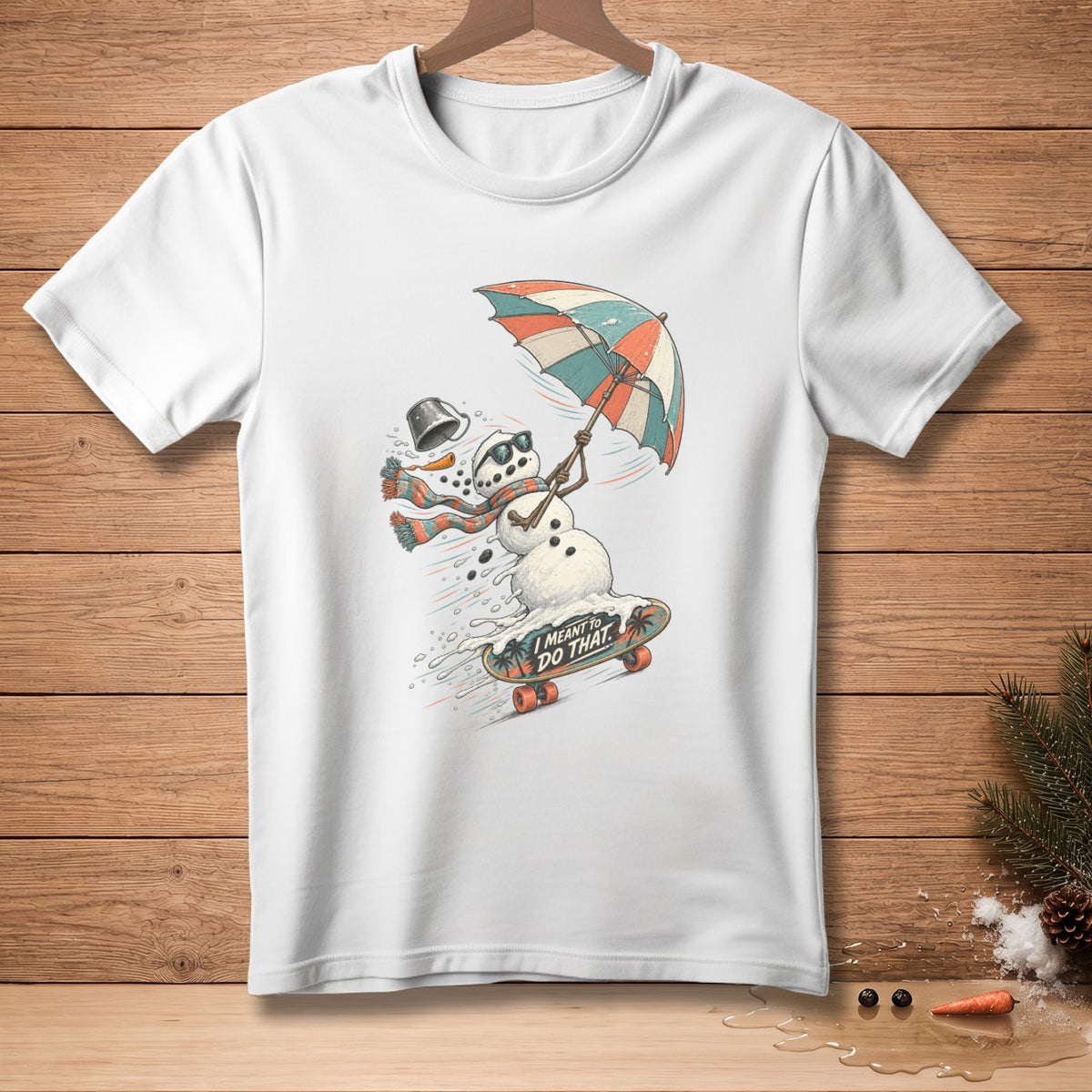 Snowman with umbrella and scarf on skateboard, text "I MEANT TO DO THAT".