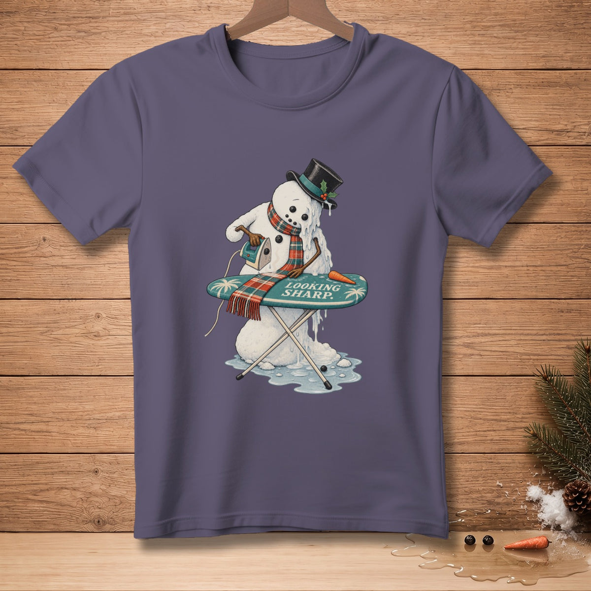 Melting snowman ironing with "LOOKING SHARP." text on ironing board.