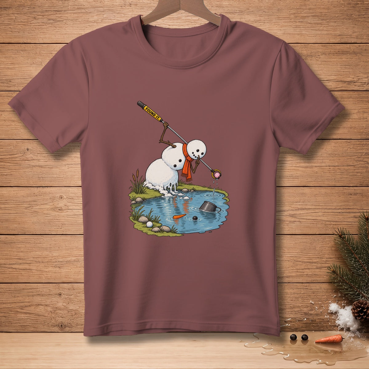 Snowman using golf club labeled "FOUND IT." to retrieve golf ball from pond.