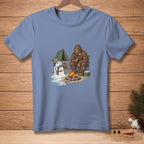 Bigfoot roasts marshmallow at campfire with melting snowman and tent.