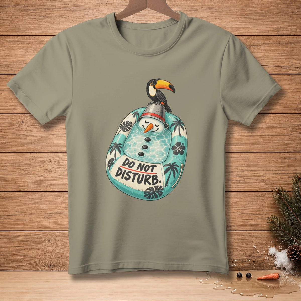 T-shirt graphic: Toucan on snowman in pool float with "Do Not Disturb" text.