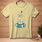 Yellow t-shirt with a cartoon snowman falling into a blue and white inner tube.