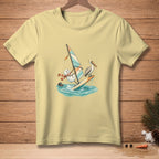 Snowman windsurfing with a pelican, on a light yellow t-shirt.