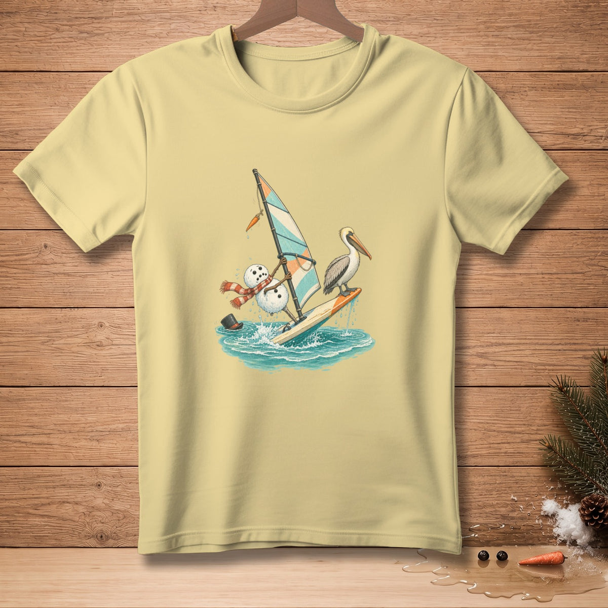 Snowman windsurfing with a pelican, on a light yellow t-shirt.