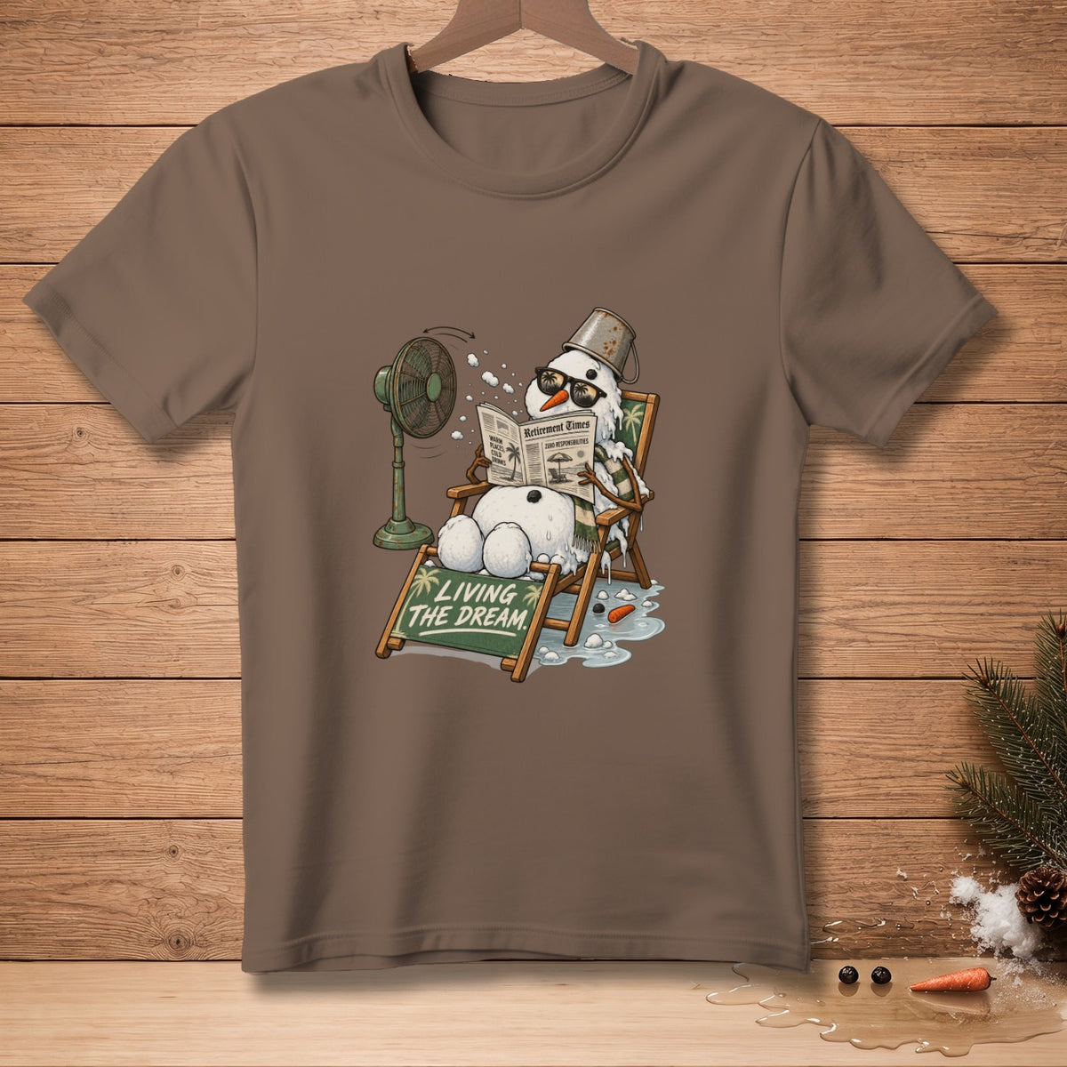 Snowman in a deck chair with fan and newspaper, "Living the Dream" text.
