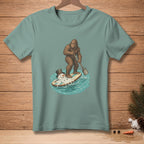 Bigfoot paddleboarding with a melting snowman on a surfboard.