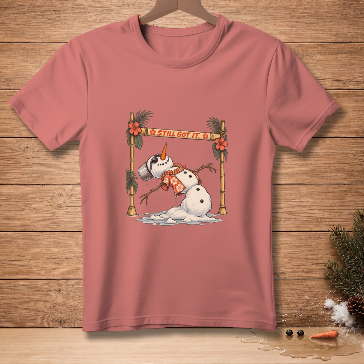 Melting snowman graphic with "Still Got It" text on a rose t-shirt.