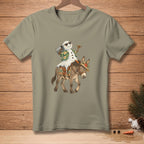 Snowman wearing sunglasses and Hawaiian shirt rides donkey with floral saddle.