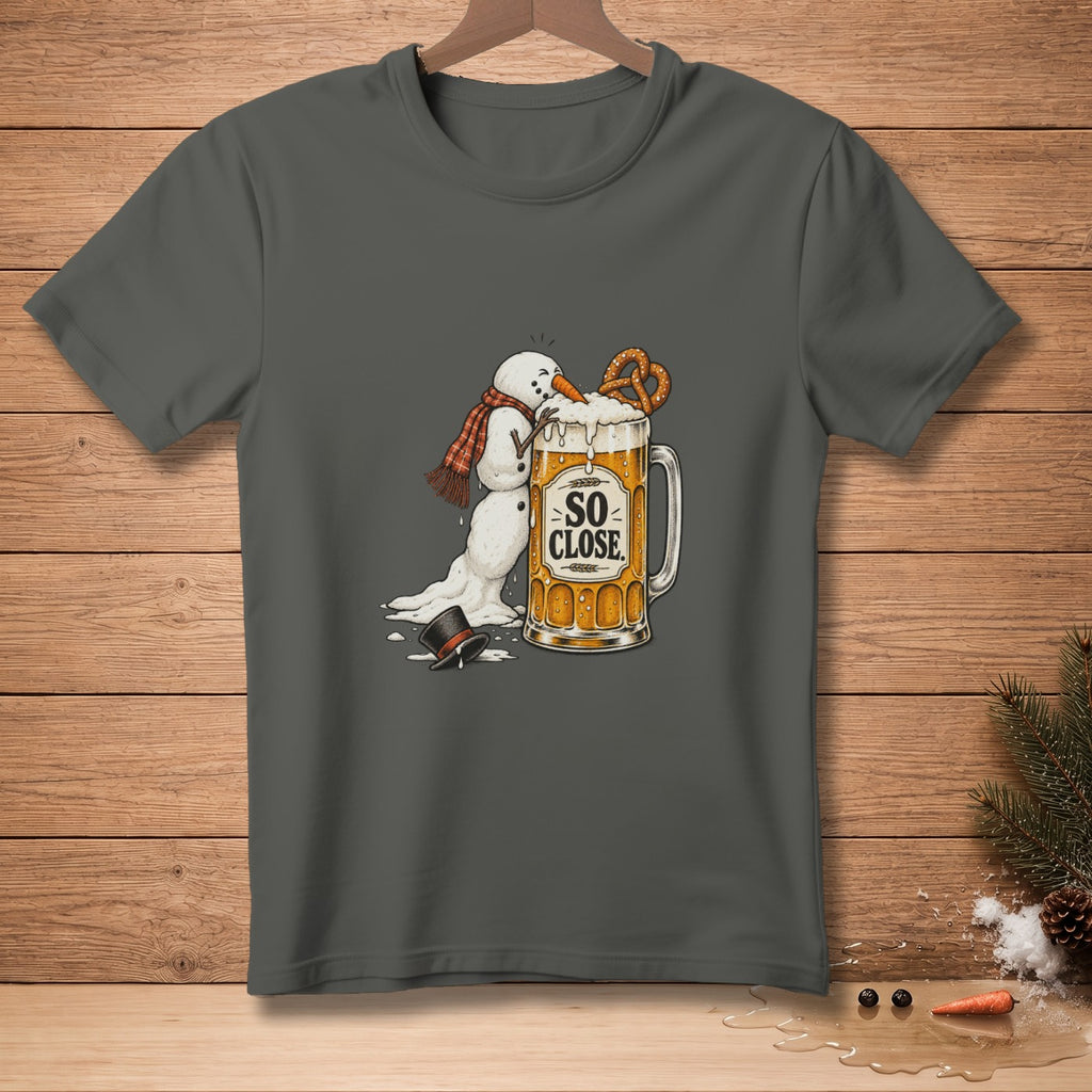 Melting snowman reaching for pretzel on beer mug with text "SO CLOSE."