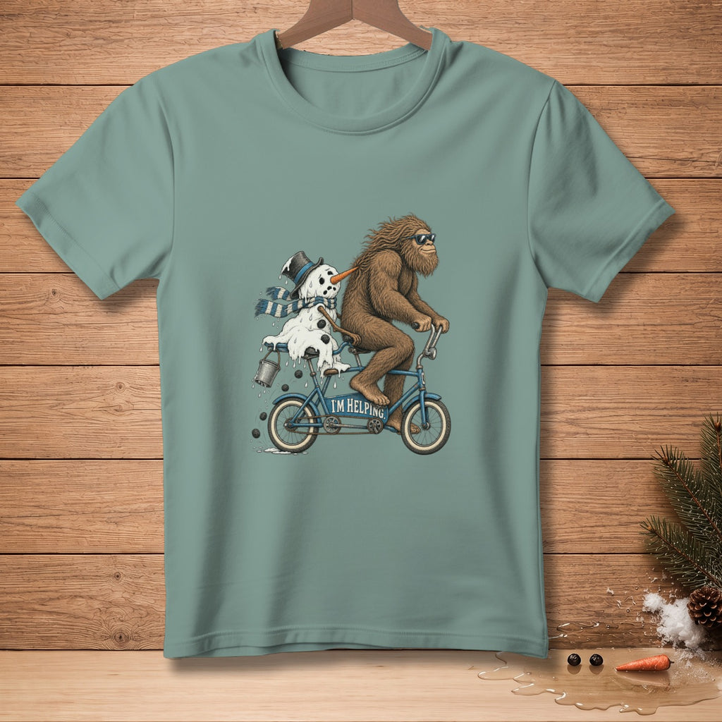Bigfoot rides a tandem bicycle with a melting snowman, reading "I'M HELPING."